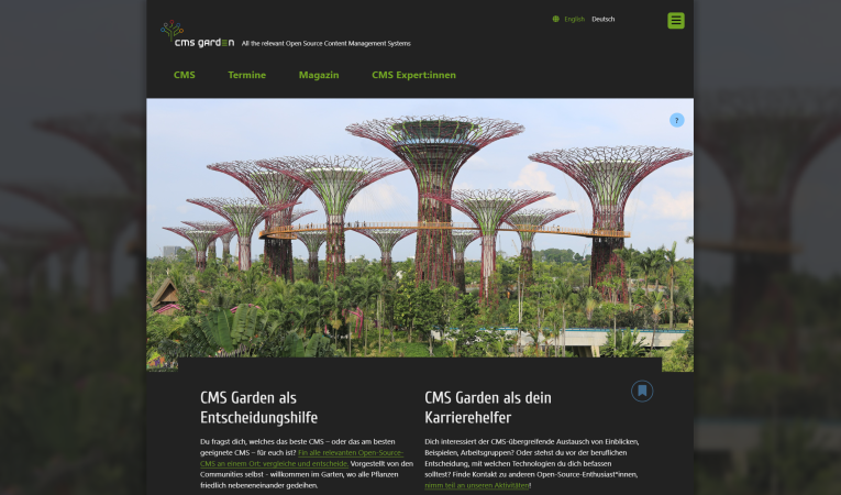 Home page in dark mode. The main image shows artificial tree structures in a park