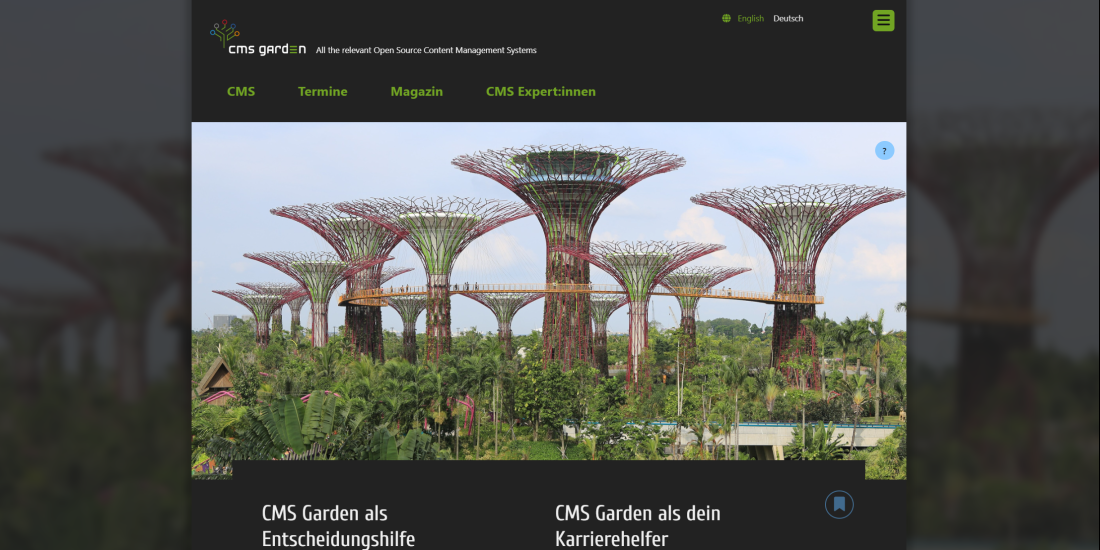 Home page in dark mode. The main image shows artificial tree structures in a park