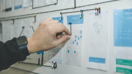 person working on blue and white paper on board photo